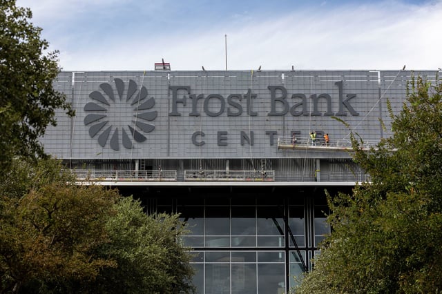 Crew members work to install the new sign at Frost Bank Center on Friday, Oct. 6, 2023 in San Antonio, Texas. The Frost Bank Center, formerly known AT&T Center, is home to the San Antonio Spurs.