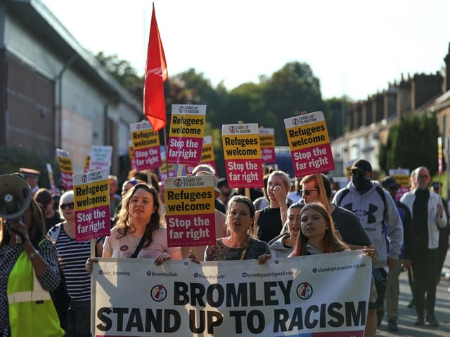 Protesters hold banners and placards during a demonstration in Orpington near London, Friday, Aug. 22, 2025 as the dilemma of how to house asylum-seekers in Britain got more challenging for the government after a landmark court ruling this week motivated opponents to fight hotels used as accommodation.(AP Photo/Alberto Pezzali)