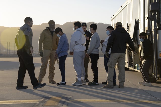 In this handout provided by the U.S. Department of Defense, U.S. Customs and Border Protection security agents guide illegal immigrants to board a removal flight on January 23, 2025 at Fort Bliss, Texas.