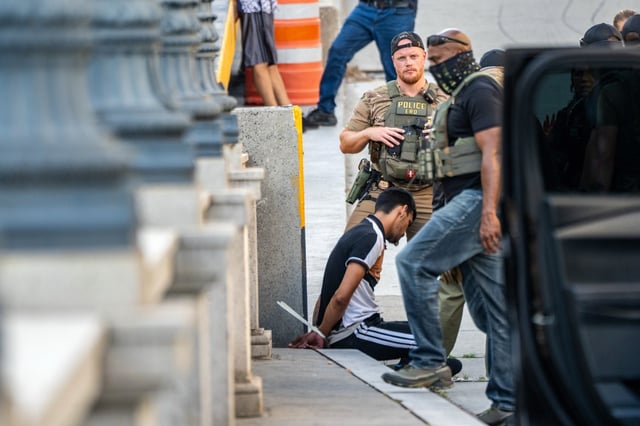 ICE and other federal agents take a delivery driver into custody at Union Station on Aug. 16, 2025 in Washington, DC. 