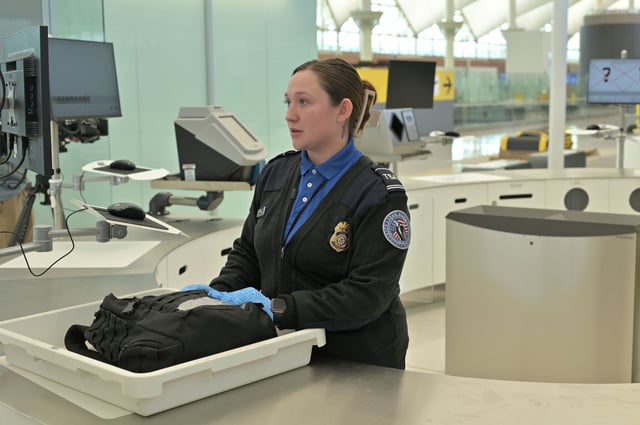 FILE: A TSA officer at the Denver International Airport.