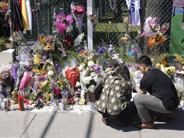 People leave flowers and pay their condolences at a memorial for the victims after the Lapu Lapu Day tragedy.