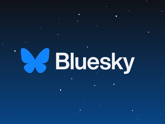 The Bluesky logo over an illustration of a starry night sky.