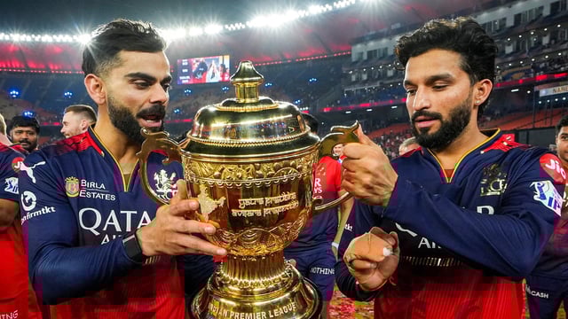 Virat Kohli and Rajat Patidar celebrate lifting the IPL 2025 trophy together.