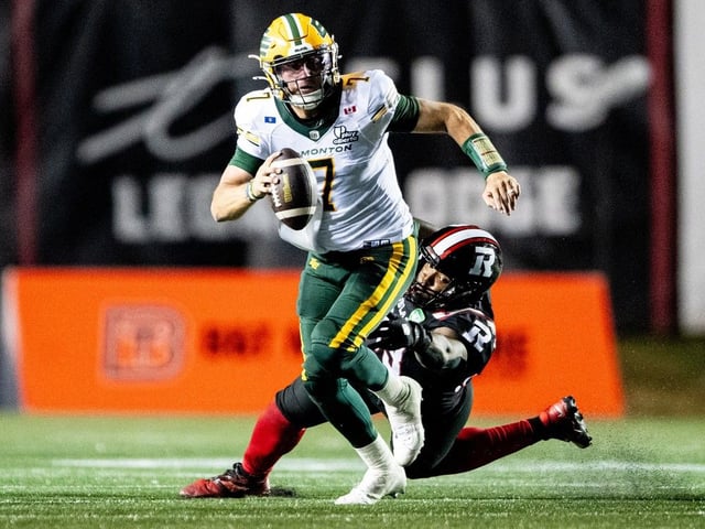 Ottawa Redblacks defensive lineman Aidan John (93) tries to tackle Edmonton Elks quarterback Cody Fajardo (7) during second half CFL action in Ottawa, on Friday, Aug. 22, 2025. 