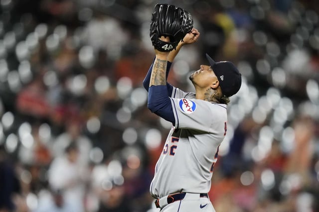 Houston Astros relief pitcher Bryan Abreu celebrates after his team's victory over the Baltimore Orioles in a baseball game, Friday, Aug. 22, 2025, in Baltimore.