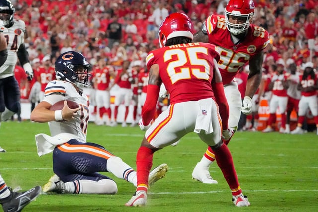 Aug 22, 2025; Kansas City, Missouri, USA; Chicago Bears quarterback Tyson Bagent (17) runs the ball as Kansas City Chiefs safety Glendon Miller (25) defends during the second half of the game at GEHA Field at Arrowhead Stadium. Mandatory Credit: Denny Medley-Imagn Images