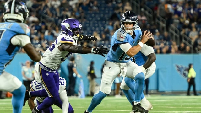 Tennessee Titans wide receiver Mason Kinsey (12) scrambles out of the grasp of Minnesota Vikings linebacker Austin Keys (56) during the second half at Nissan Stadium. Mandatory Credit: Steve Roberts-Imagn Images