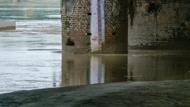 A view of the Yamuna River waters at the Old Iron Bridge near Yamuna Bazar, where levels remain high despite a slight decrease