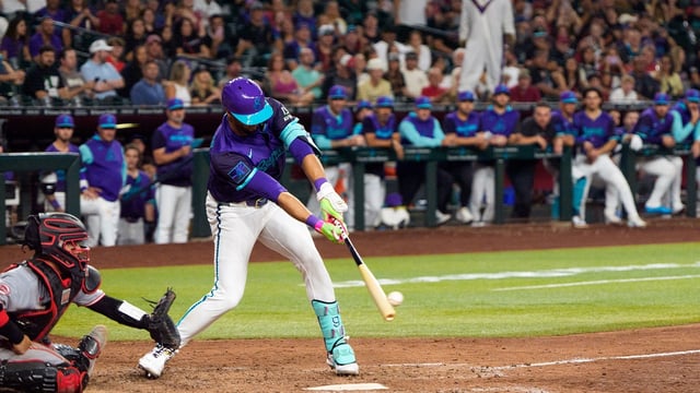 Aug 22, 2025; Phoenix, Arizona, USA; Arizona Diamondbacks outfielder Lourdes Gurriel Jr. (12) reacts after hitting the game winning RBI to score outfielder Corbin Carroll (7) (not shown) in the eleventh inning against the Cincinnati Reds at Chase Field. The Diamondback beat the Reds 6-5. Mandatory Credit: Allan Henry-Imagn Images