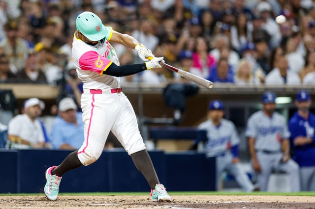 Aug 22, 2025; San Diego, California, USA; San Diego Padres shortstop Xander Bogaerts (2) hits a sacrifice fly during the fourth inning against the Los Angeles Dodgers at Petco Park. Mandatory Credit: David Frerker-Imagn Images
