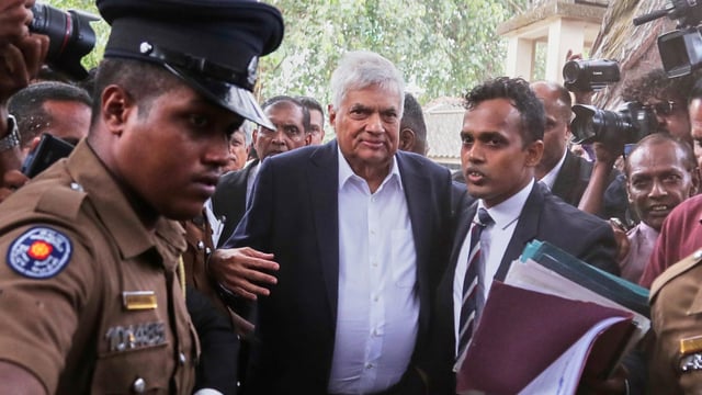 Ranil Wickremesinghe, centre, is taken to court in Colombo on Friday