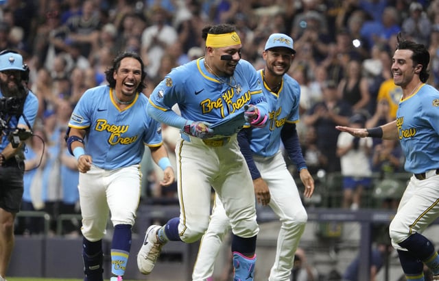 Aug 22, 2025; Milwaukee, Wisconsin, USA; Milwaukee Brewers catcher William Contreras (24) is chased by his teammates after hitting a walk off home run to defeat the San Francisco Giants in the bottom of the ninth inning 5-4 at American Family Field. Mandatory Credit: Michael McLoone-Imagn Images