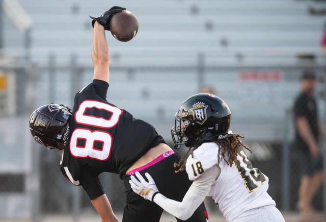 Centennial’s Ty Plinski, (#80), catches a pass, one-handed for a touchdown over Servite’s Jace Wells, (#18), during a game at Centennial High School in Corona, Friday, Aug. 22, 2025.  (Photo by John Valenzuela/Contributing Photographer)