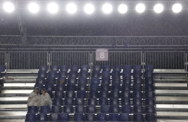 Tennis - WTA 500 - Monterrey Open - Club Sonoma, Monterrey, Mexico - August 22, 2025 Spectators take cover as rain suspends play REUTERS/Daniel Becerril