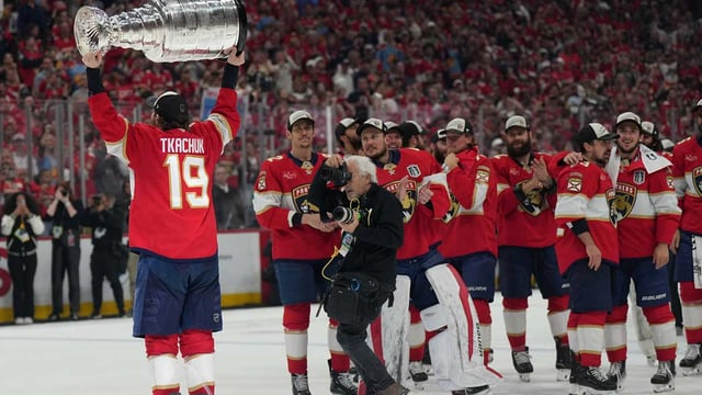 Jun 17, 2025; Sunrise, Florida, USA; Florida Panthers left wing Matthew Tkachuk (19) hoist the Stanley Cup after game six of the 2025 Stanley Cup Final against the Edmonton Oilers at Amerant Bank Arena. Mandatory Credit: Jim Rassol-Imagn Images