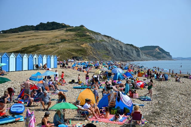 People enjoy the hot weather at Charmouth beach in West Dorset, on 15 August, 2025 (Photo: Getty Images)