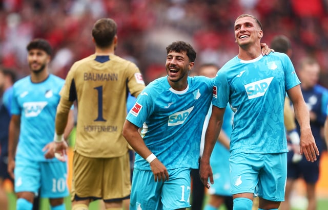 Soccer Football - Bundesliga - Bayer Leverkusen v TSG 1899 Hoffenheim - BayArena, Leverkusen, Germany - August 23, 2025  TSG 1899 Hoffenheim's Grischa Promel and TSG 1899 Hoffenheim's Umut Tohumcu celebrate after the match REUTERS/Leon Kuegeler