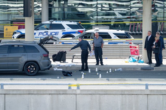 Evidence is pictured at the scene of police-involved shooting at the departures area of terminal 1 at Toronto Pearson International Airport, in Mississauga, Ont., on Thursday, April 24, 2025. THE CANADIAN PRESS/Arlyn McAdorey