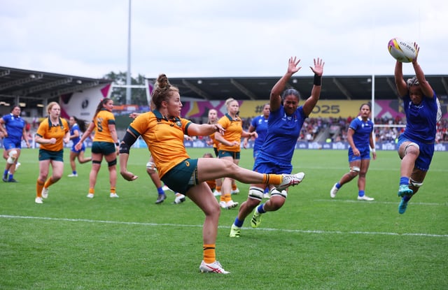 Rugby Union - Women's World Cup 2025 - Pool A - Australia v Samoa - Salford Community Stadium, Salford, Britain - August 23, 2025 Australia's Maya Stewart kicks the ball clear as Samoa's Sui Pauaraisa attempts to charge it down Action Images via Reuters/Craig Brough