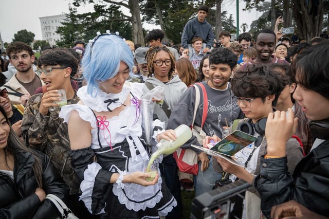 Jackie Chen passes out complimentary matcha while dressed as a “matcha maid” during a performative male contest at Alamo Square Park in San Francisco.