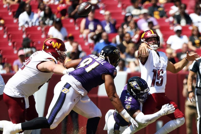 Washington Commanders quarterback Sam Hartman (15) fumbles the ball during an NFL football game against the Baltimore Ravens, Saturday, Aug. 23, 2025, in Landover. (AP Photo/Daniel Kucin Jr.)