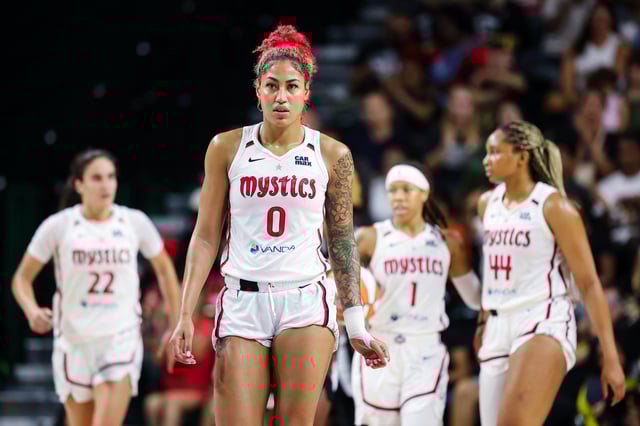 Shakira Austin #0 of the Washington Mystics looks on during the second half of the game against the Las Vegas Aces at EagleBank Arena on July 10, 2025 in Fairfax, Virginia..