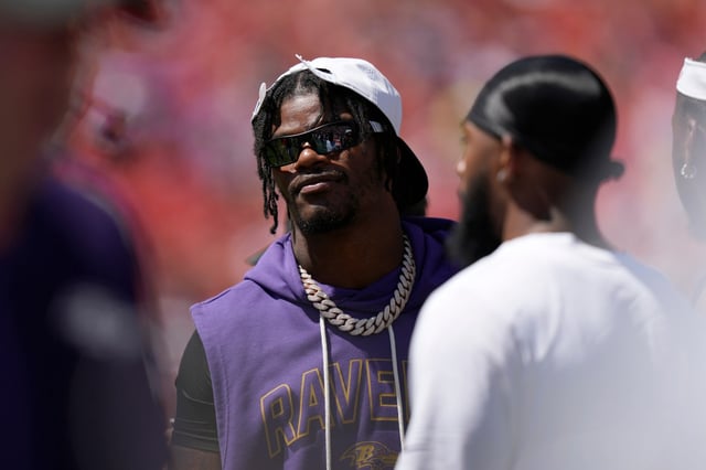Baltimore Ravens quarterback Lamar Jackson watches from the sidelines during the first half of a preseason NFL football game against the Washington Commanders Saturday, Aug. 23, 2025, in Landover, Md. (AP Photo/Stephanie Scarbrough)