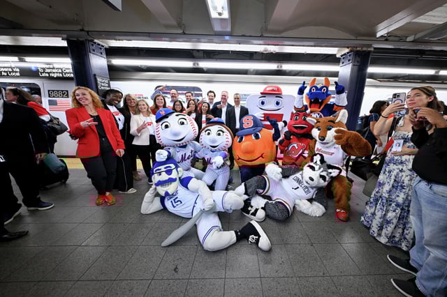 ESPN execs and various sports mascots celebrate the rollout of the new ESPN streaming service at a marketing event in the New York City subway.