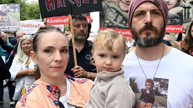 Harvey’s parents Gillian Sherratt and Stephen Morrison, with Remy, two, at a protest in Dublin on Saturday