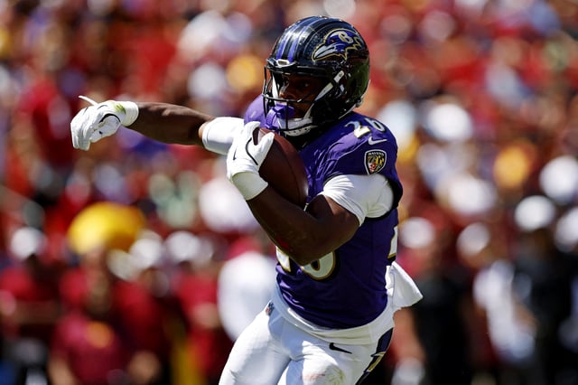 Aug 23, 2025; Landover, Maryland, USA; Baltimore Ravens running back Rasheen Ali (26) runs the ball for a touchdown during the first quarter against the Washington Commanders at Northwest Stadium. Mandatory Credit: Peter Casey-Imagn Images