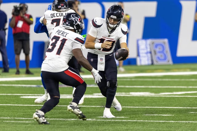 Aug 23, 2025; Detroit, Michigan, USA; Houston Texans quarterback Graham Mertz (18) hands off the ball to running back Dameon Pierce (31) during the first half against the Detroit Lions at Ford Field. Mandatory Credit: David Reginek-Imagn Images