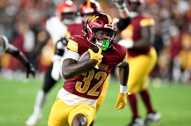 Jacory Croskey-Merritt #32 of the Washington Commanders rushes for a touchdown in the first quarter against the Cincinnati Bengals during the NFL Preseason 2025 game between Cincinnati Bengals and Washington Commanders at Northwest Stadium on August 18, 2025 in Landover, Maryland.
