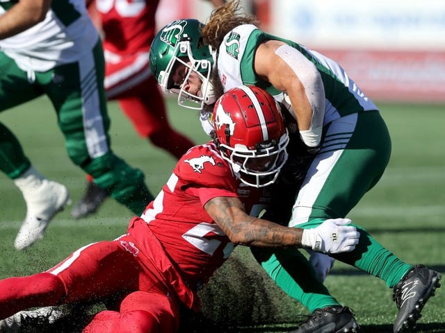 Calgary Stampeders Jaydon Grant stops Saskatchewan Roughriders A.J. Ouellette in first half CFL action at McMahon stadium in Calgary on Saturday, August 23, 2025.