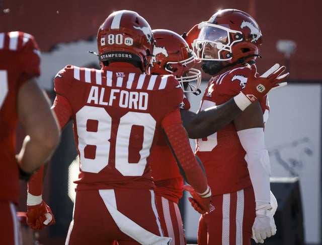 Calgary Stampeders' Jalen Philpot, right, celebrates his touchdown with teammates during first half CFL football action against the Saskatchewan Roughriders in Calgary, Saturday, Aug. 23, 2025. THE CANADIAN PRESS/Jeff McIntosh