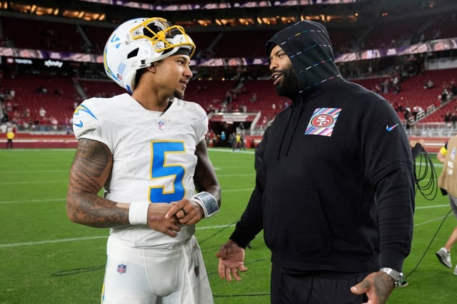 Los Angeles Chargers quarterback Trey Lance (5) talks with San Francisco 49ers offensive tackle Trent Williams after an NFL preseason football game in Santa Clara, Calif., Saturday, Aug. 23, 2025. (AP Photo/Godofredo A. Vásquez)