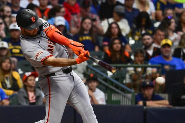 Aug 23, 2025; Milwaukee, Wisconsin, USA;  San Francisco Giants second baseman Casey Schmitt (10) hits a double to drive in a run in the sixth inning against the Milwaukee Brewers at American Family Field. Mandatory Credit: Benny Sieu-Imagn Images