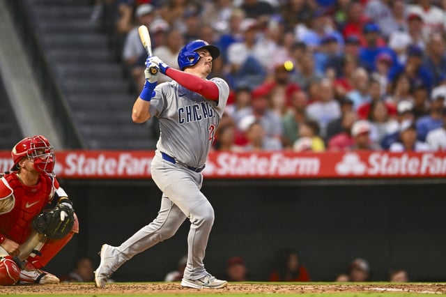 Aug 23, 2025; Anaheim, California, USA; Chicago Cubs catcher Reese McGuire (20) hits a grand slam against the Los Angeles Angels during the fourth inning at Angel Stadium. Mandatory Credit: Jonathan Hui-Imagn Images