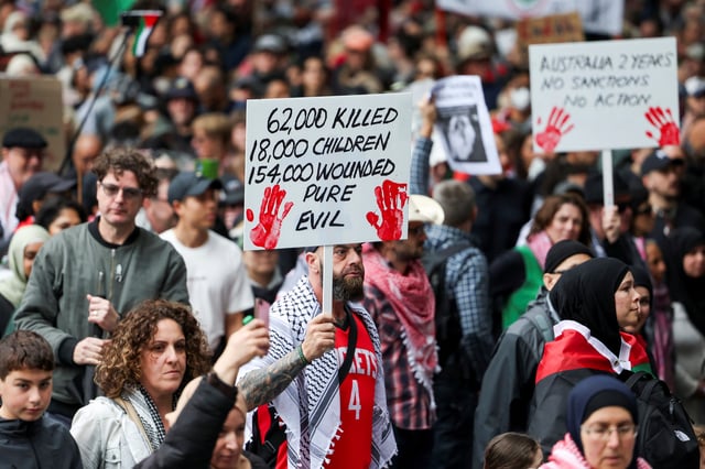 Demonstrators hold placards as they take part in the 'Nationwide March for Palestine' protest in Sydney, Australia, August 24, 2025. REUTERS/Hollie Adams