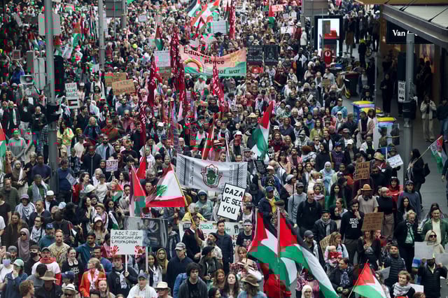Demonstrators hold placards as they take part in the 'Nationwide March for Palestine' protest in Sydney, Australia, August 24, 2025. REUTERS/Hollie Adams