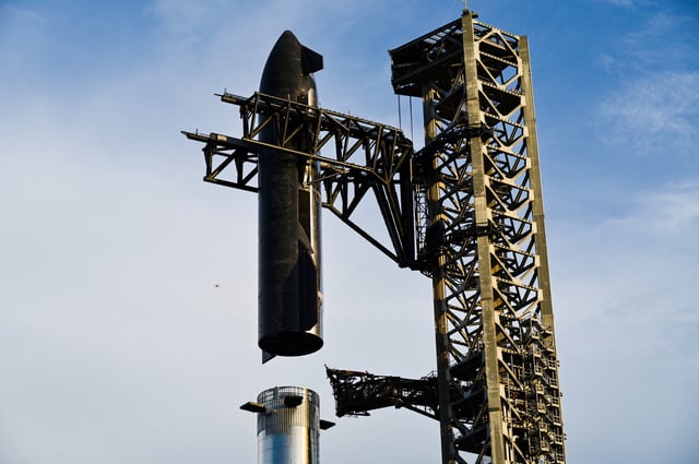 The SpaceX Starship spacecraft is hoisted along the launch tower for stacking atop the heavy booster in preparation for its 10th test flight from the company's complex in Starbase, Texas, U.S., August 23, 2025. REUTERS/Steve Nesius