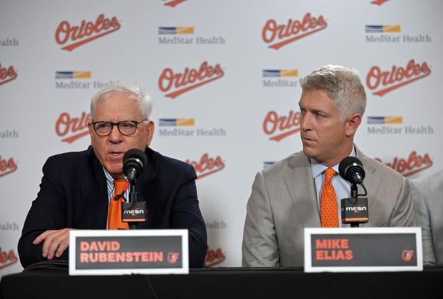 Orioles owner David Rubenstein, left, and Executive Vice President and General Manager Mike Elias announce the signing of Orioles catcher Samuel Basallo to a eight-year contract extension covering the 2026-33 seasons with a club option for 2034 during a press conference at Oriole Park at Camden Yards. (Kenneth K. Lam/staff)