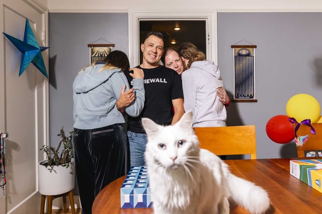 Calder Storm, left, and Tristan Storm, right, parents of two teens, one who is nonbinary and one who is a transgender girl, pose for a portrait in their home in San Francisco on Friday.