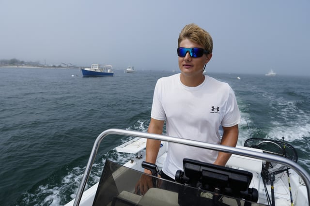 David Lancaster, an avid fisherman who recently captured drone footage off a white shark off of Scarborough, Maine, motors out to sea, Wednesday, Aug. 13, 2025, in Scarborough. (AP Photo/Robert F. Bukaty)