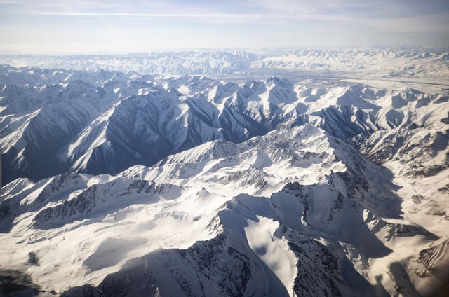 An aerial view taken from a commercial plane shows Tian Shan Range in Kyrgyzstan on April 29, 2021.