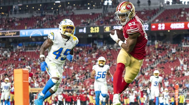 August 23, 2025; Santa Clara, California, USA; San Francisco 49ers wide receiver Terique Owens (83) scores a touchdown against Los Angeles Chargers cornerback Myles Purchase (49) during the fourth quarter at Levi's Stadium. Mandatory Credit: Kyle Terada-Imagn Images