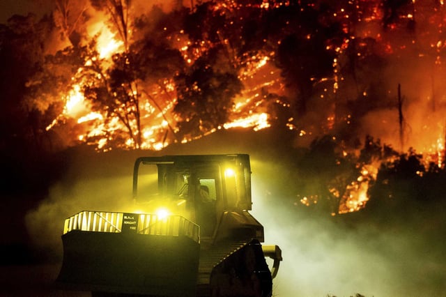 A bulldozer clears vegetation as the Pickett Fire approaches in the Aetna Springs area of Napa County on Saturday.