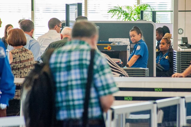 Passengers pass through a Transportation Security Administration checkpoint at Hobby Airport.