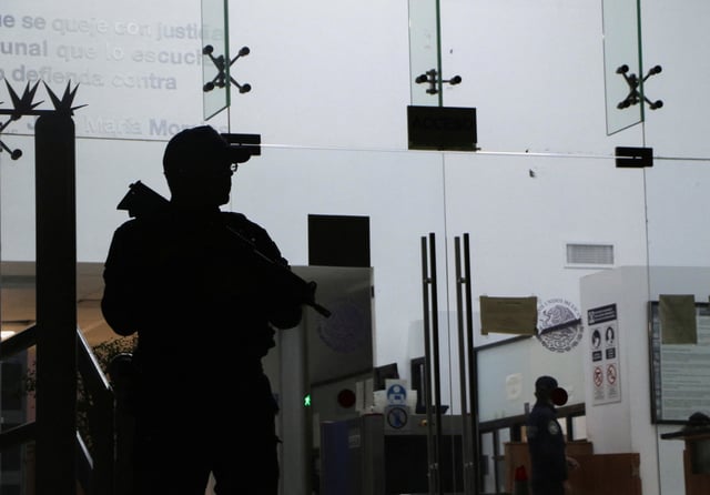 A police officer stands guard outside a courthouse as Mexican boxer Julio Cesar Chavez Jr. (not pictured) appears via videoconference following his deportation from the United States and transfer to a federal prison, following his arrest in the United States in July, after a warrant was issued in Mexico for alleged involvement in arms trafficking and organized crime, according to local media, in Hermosillo, Mexico, August 23, 2025. REUTERS/Alonso Castillo
