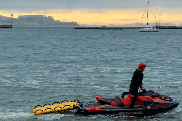 A rescuer searches the water outside San Francisco’s Aquatic Park on Saturday afternoon for a swimming who went missing that morning.